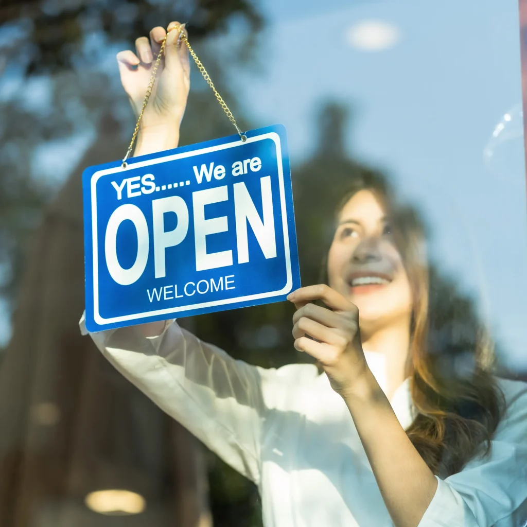 Small Business Owner Hanging Open Sign